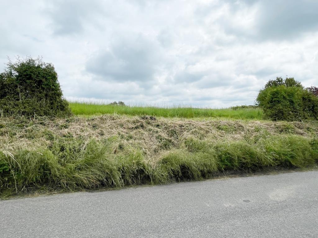 Lot: 73 - DEVELOPMENT OPPORTUNITY IN SUFFOLK VILLAGE LOCATION - View of the land with planning for sunken house in Suffolk village